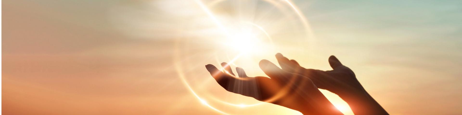 hands holding up into the sun